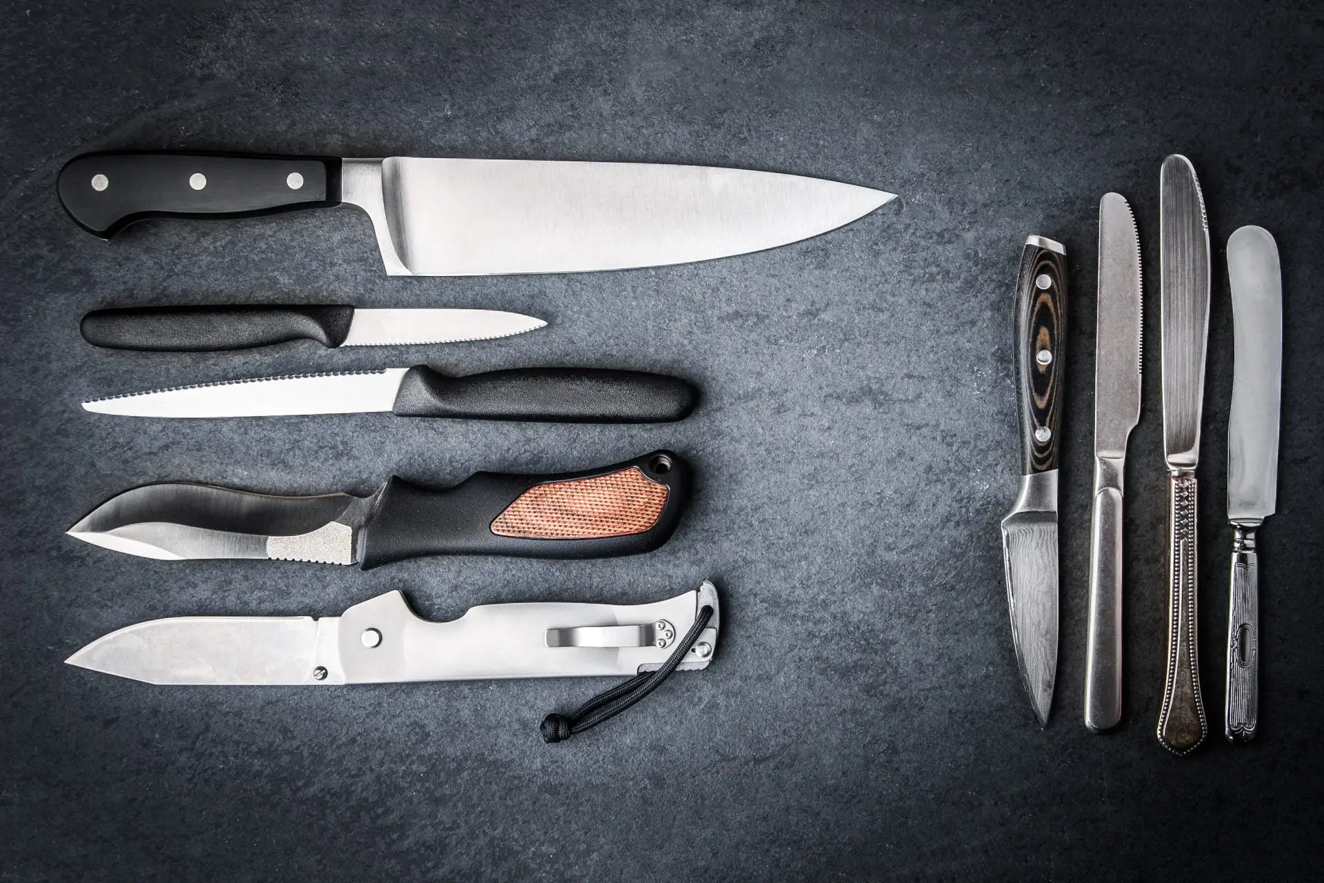 Collection of sharpened knives on grey stone Sharper Focus Ltd Bristol
